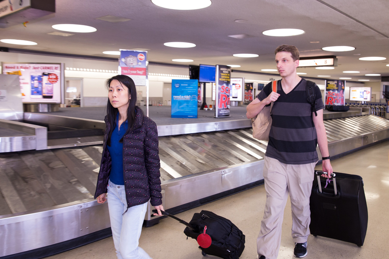 Danielle Wang and her husband, Jeff, arrive at Newark International Airport on Aug. 9. (Dai Bing/Epoch Times)