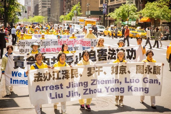 Over 8,000 Falun Dafa practitioners march in a parade for World Falun Dafa day, in Manhattan, on May 14, 2014. From 2002-2012 Zhou Yongkang has the principal responsibility for the persecution of Falun Gong practitioners. (Edward Dai/Epoch Times)