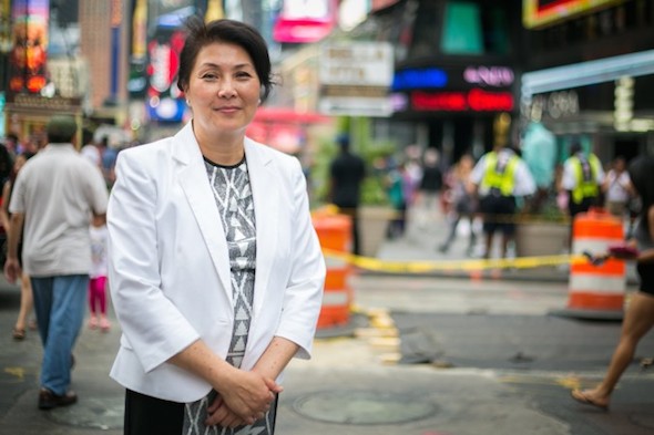 Judy Chen, who has been harassed in Flushing, Queens, because she practices Falun Gong, a spiritual practice based on principles of truthfulness, compassion, and tolerance, poses on Times Square, Manhattan, New York, on June 25, 2014. (Benjamin Chasteen/Epoch Times)