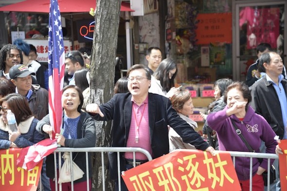 Micheal Chu yells and curses at Falun Gong practitioners during a parade in Flushing, Queens, New York City, on April 26, 2014. Chu heads an organization devoted to harassing practitioners. (Gary Du/Epoch Times)