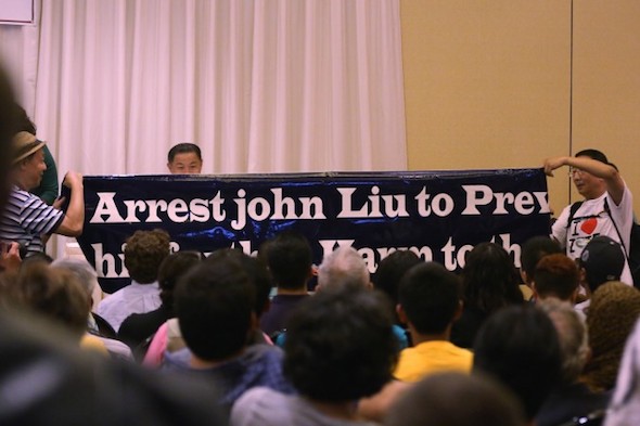 Protesters at the candidate forum, with a banner that reads "“Arrest John Liu to Prevent his further Harm to the U.S.” Liu, a candidate for state senator, was a speaker at the Forum, which took place at the Sheraton Hotel in Flushing, Queens, New York City, on Tuesday, Aug. 19, 2014. (Epoch Times)