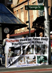 Falun Gong supports display a banner of torture re-enactments in Sydney July, 2005 to mark the six years since the Falun Gong persecution. Photo: Getty Images
