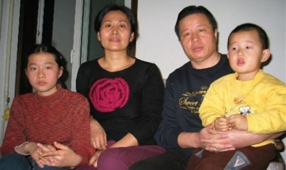 In this photo taken Jan. 6, 2006 and released by Hu Jia, Gao Zhisheng, a human rights lawyer, second right, poses for photos with his son Gao Tianyu, right, and his wife Geng He, second left, and daughter Geng Ge, left, at their home in Beijing, China. A fiery critic of China’s authoritarian government whose imprisonment and accounts of torture triggered international criticism of Beijing appears set for release Thursday, Aug. 7, 2014 amid mounting concerns the authorities will continue to deny the lawyer freedom outside prison. (AP Photo/Hu Jia)