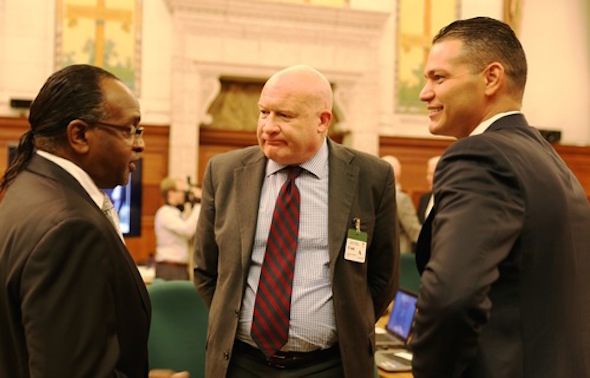 Journalist Ethan Gutmann (center) and Dr. Damon Noto (right), representative of DAFOH, chat with MP Tyrone Benskin.