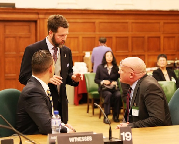 Journalist Ethan Gutmann (right) and Dr. Damon Noto (left), representative of DAFOH, chat with MP Scott Reid, chair of Canadian Parliament's human rights subcommittee.
