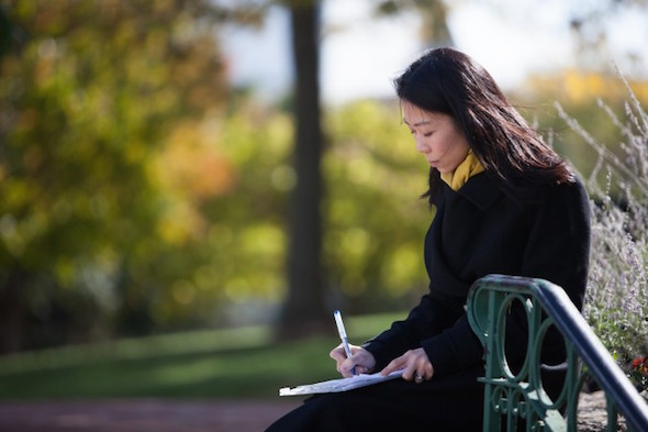 Danielle Wang makes notes before speaking at a press conference calling for her father to be freed, opposite the Chinese Embassy in Washington, D.C., on Oct. 24, 2014. Danielle has worked for 13 years seeking to gain freedom for her father, a prisoner of conscience in China. (Courtesy Danielle Wang)
