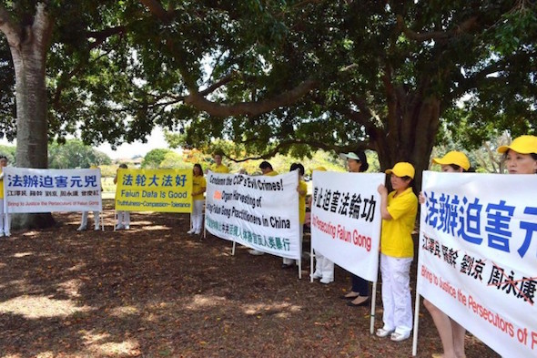 Falun Gong practitioners hold signs calling for an end to the persecution of the spiritual discipline in China, in Brisbane, Australia prior to the G20 Summit. Practitioners held signs like these on the roadside as Chinese Communist Party leader Xi Jinping's motorcade sped past, going from Brisbane to Canberra. (Minghui.org)