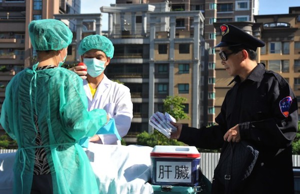 Members of the spiritual movement Falun Gong act out a scene of stealing human organs to sell during a demonstration in Taipei on July 20, 2014 against China’s persecution of the group. China outlawed Falun Gong as an ‘evil cult’ in 1999 and has since detained tens of thousands of members. (Mandy Cheng/AFP/Getty Images)