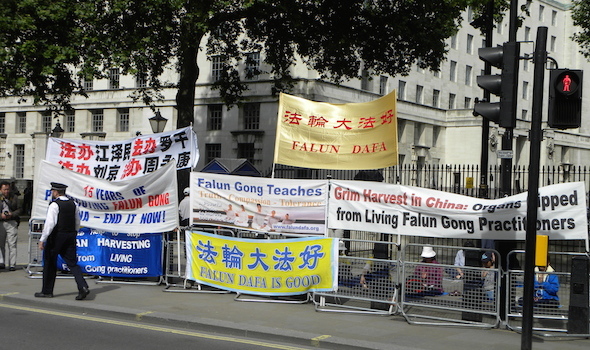 A similar group of activists staged a protest near Downing Street in London on 17 June 2014 to condemn the persecution of Falun Gong activists in China. Photo by Reporter#19616. Copyright Demotix