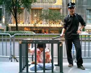 (Photo: Reenactment  of torture of a Falun Gong practitioner in China, Brenden Themes, Wikimeida)