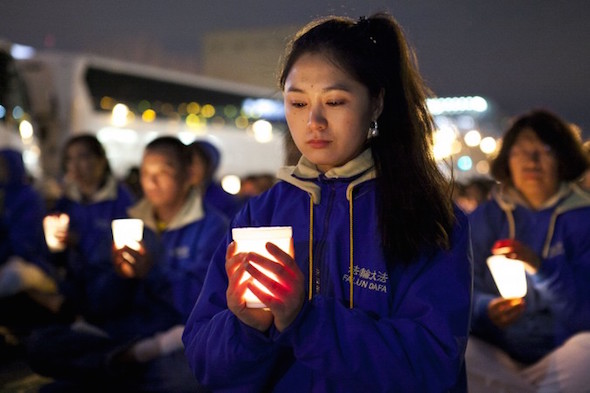 Falun Dafa practitioners hold a candlelight vigil as a peaceful protest near the Chinese Consulate in New York, on April 25, 2014. The protest is against the Chinese regime’s 15-year persecution of the practice. (Samira Bouaou/Epoch Times)