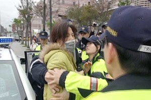 Police officers arrest a protesting member of pro-unification Concentric Patriotic Association of the R.O.C., yesterday. Taipei's newly appointed Xinyi District police precinct chief Wu Jing-tian made a striking first impression on citizens yesterday by ordering the arrest of several members of the infamous organization during his first official command.(CNA)