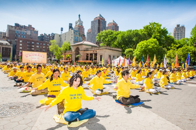 Falun Gong practitioners meditate at Union Square in New York as they celebrate World Falun Dafa Day on May 12, 2016. (Youzhi Ma/Epoch Times)