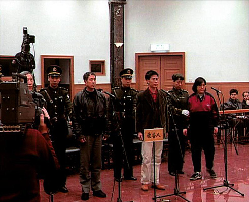 Wang Zhiwen (3rd L) stands trial with three other Falun Dafa practitioners on Dec. 26, 1999. This show trial was meant to influence other practitioners, helping convince them to give up the spiritual discipline. (via Wang family)